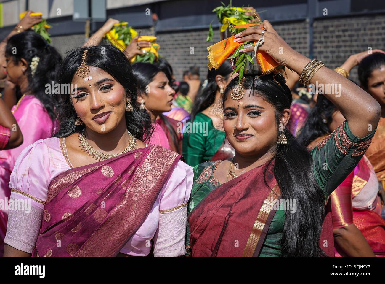London, UK. 07th Sep, 2025. Participating women in vibrant saris carry offerings of milk in containers on their heads, and burning incense. Hindu devotees, mostly from the Tamil community, take part in the annual Chariot Festival with a vibrant and cheerful procession from the Sivan Kovil Temple through the streets of Lewisham. The deities of Ganesha and Lord Shiva are carried in decorated chariots. Devotees make offerings of milk, burning incense, coconuts or fruit. Credit: Imageplotter/Alamy Live News Stock Photo