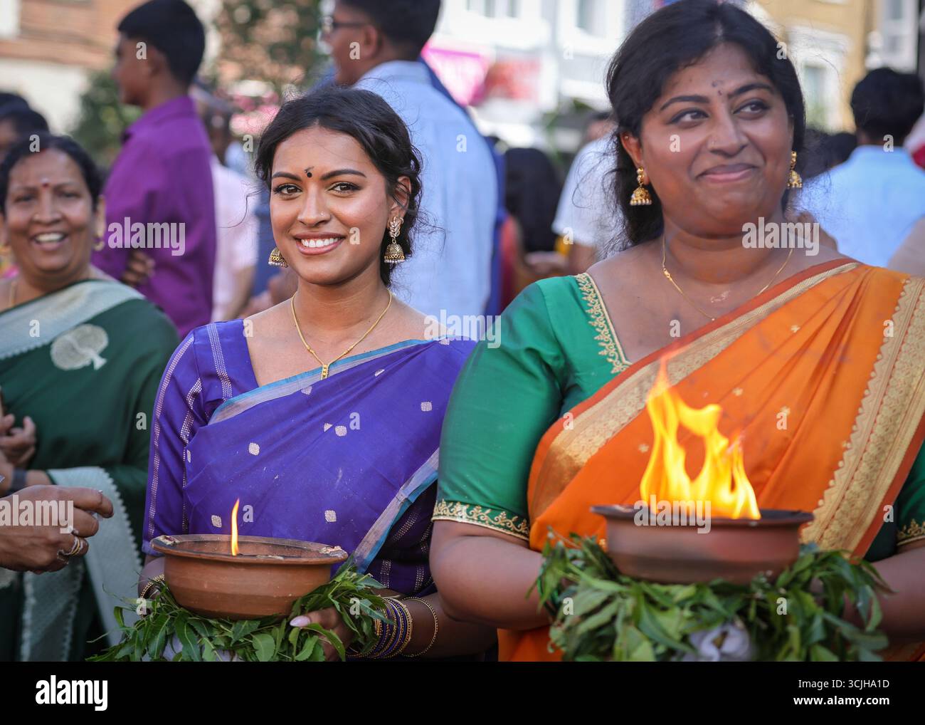 London, UK. 07th Sep, 2025. Participating women in vibrant saris carry offerings of milk in containers on their heads, and burning incense. Hindu devotees, mostly from the Tamil community, take part in the annual Chariot Festival with a vibrant and cheerful procession from the Sivan Kovil Temple through the streets of Lewisham. The deities of Ganesha and Lord Shiva are carried in decorated chariots. Devotees make offerings of milk, burning incense, coconuts or fruit. Credit: Imageplotter/Alamy Live News Stock Photo