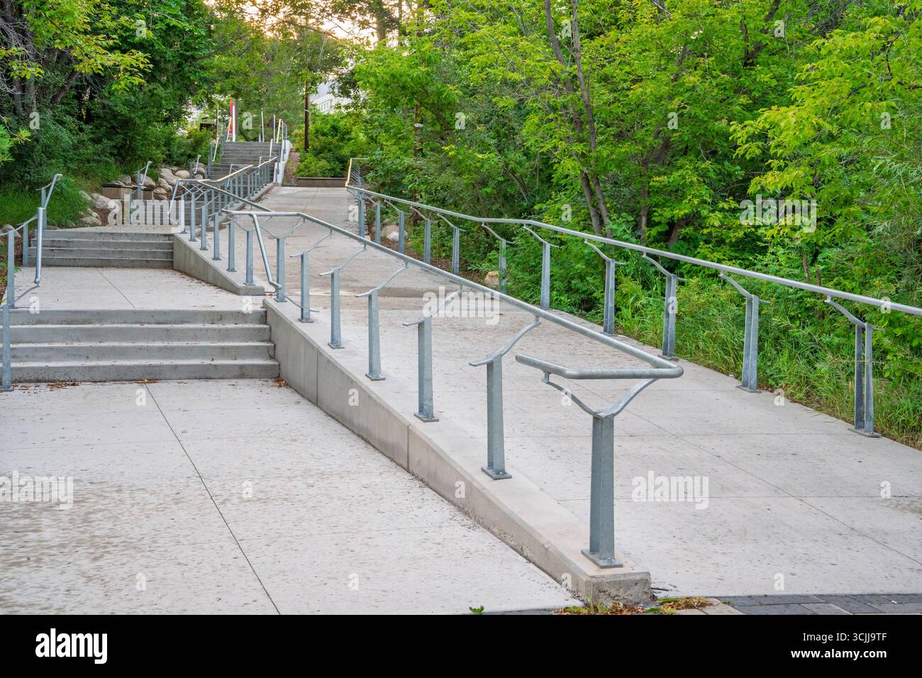 Walkway with a railing and steps leading up to a building. The railing ...
