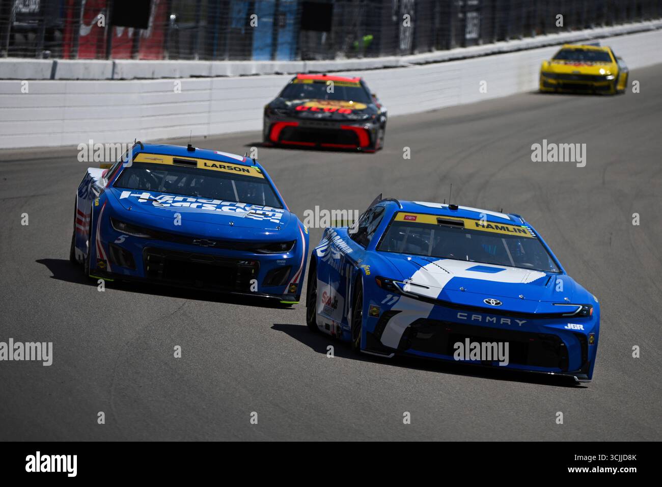 Madison I'll Raceway Kyle Larson (5) and Denny Hamlin (11) race into Turn 3 during a NASCAR ...