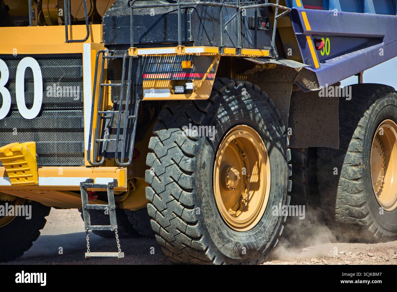 mining truck macro close on wheels driving on gravel road, open pit mine, large industrial operation to extract diamonds, Stock Photo