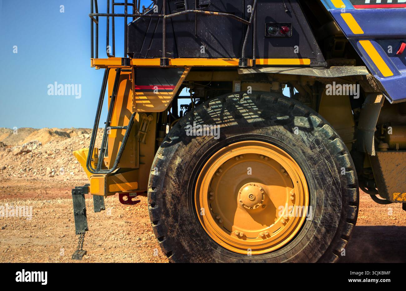 mining truck macro close on wheels driving on gravel road, open pit mine, large industrial operation to extract diamonds, Stock Photo