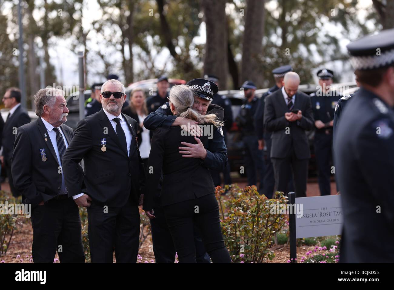 Attendees gather prior to the funeral service for Detective Leading ...