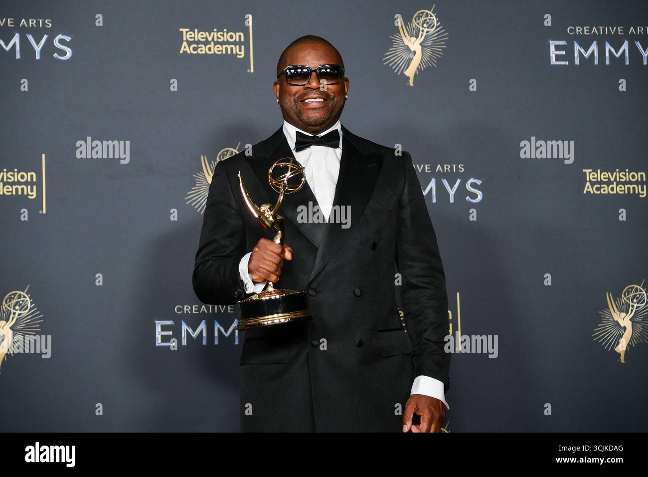 Tony Russell poses in the press room with the award for music direction