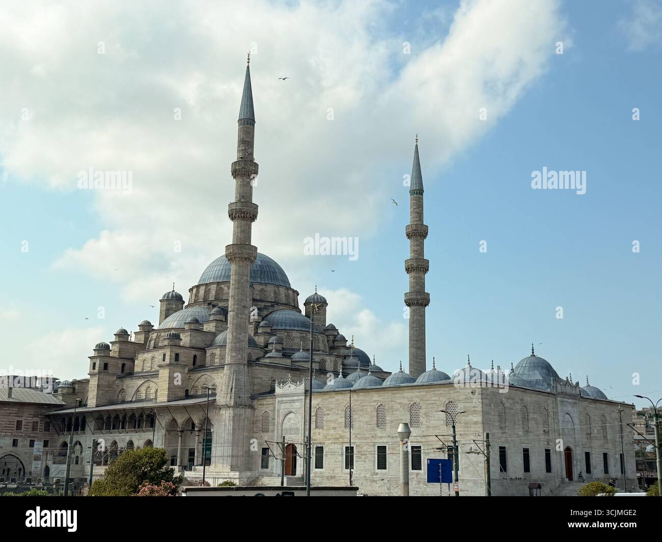 Historic mosque in Istanbul with tall minarets under blue sky ...