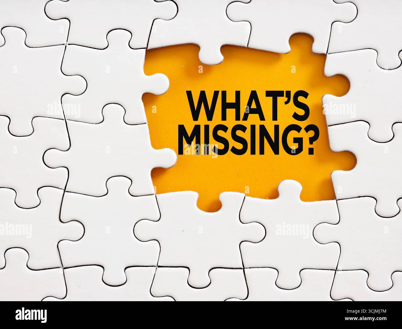 White jigsaw puzzle revealing the question what's missing? Problem solving, finishing a task and finding solutions concept. Stock Photo