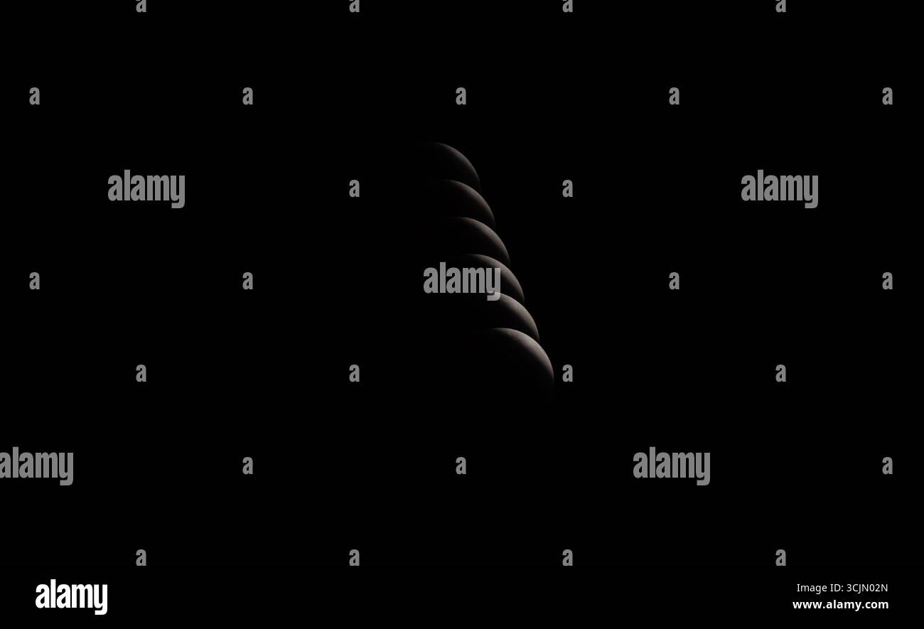 Lunar eclipse shadow sequence composite in night sky, Tete, Mozambique Stock Photo