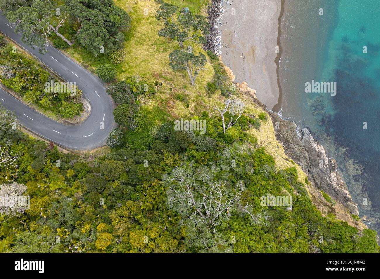 Aerial view of the winding road snaking along the rugged coastline ...