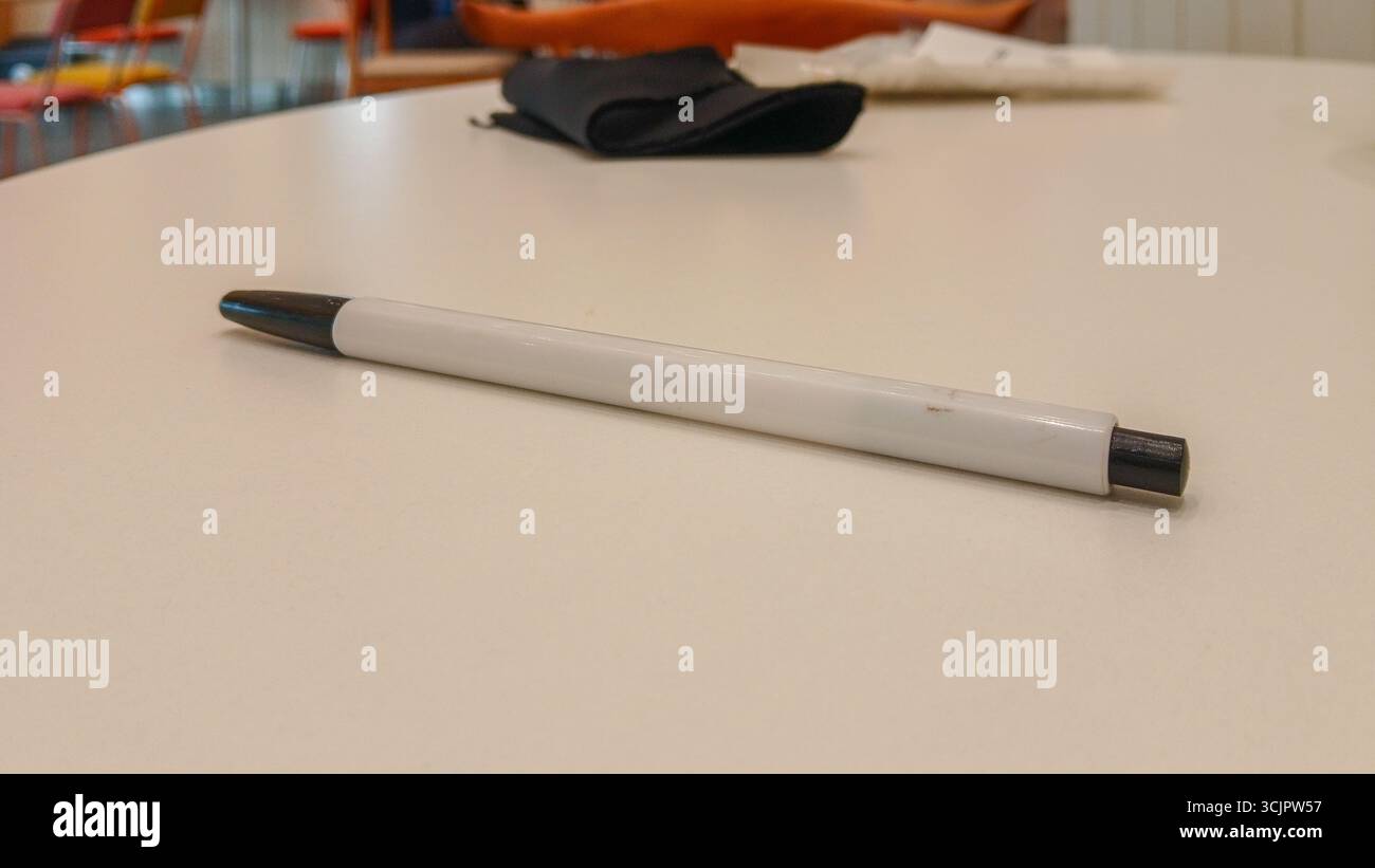 A ballpoint pen on a white table Stock Photo