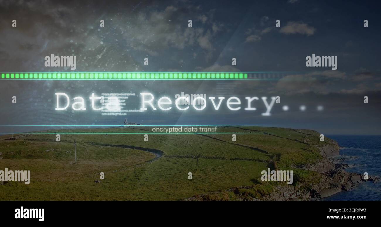 Digital overlay progressing at coastal headland, with Data Recovery bar and encrypted data transfer Stock Photo