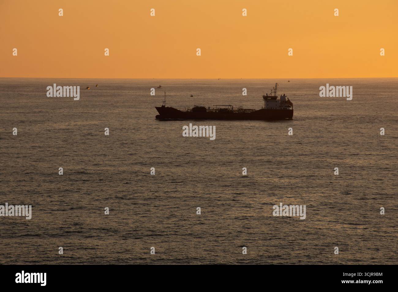 Cargo ship sailing sunset hi-res stock photography and images - Alamy