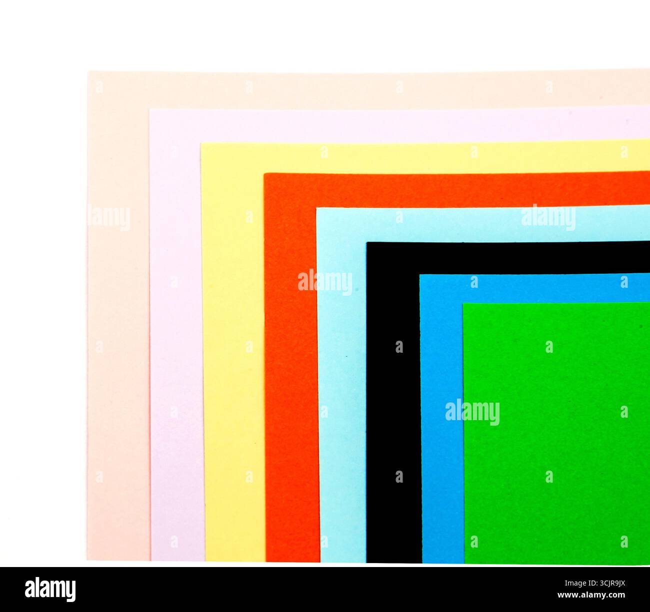Multicolored paper on a white background top view. Stock Photo
