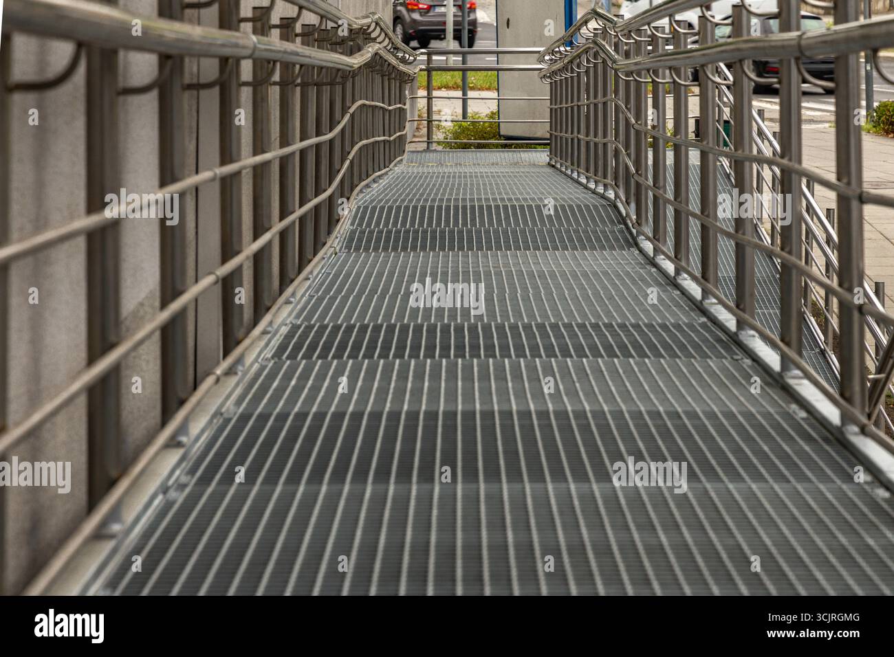 Accessible ramp for disabled people, metal ramp with handrails for strollers and disabled people, architectural accessibility of public buildings Stock Photo