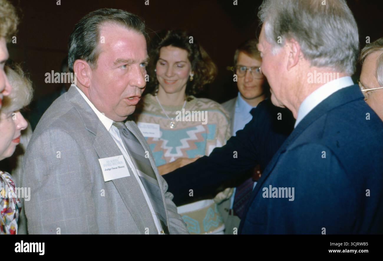 Texas Sen. OSCAR MAUZY, l, greets former U.S. President JIMMY CARTER after making a speech before executives along with legendary musician WILLIE NELSON at a Habitat for Humanity fund-raiser in Austin on August 2, 1989. Stock Photo