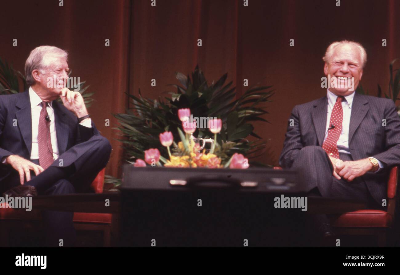 Former U.S. Presidents JIMMY CARTER, l, and GERALD FORD, r, discuss diplomacy during an appearance at Texas A&M University on April 1, 1986. Stock Photo