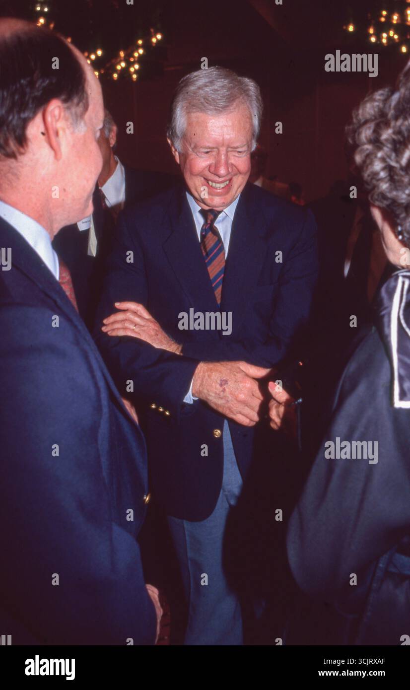 Former U.S. President JIMMY CARTER talks to guests after making a speech before executives along with legendary musician Willie Nelson (not shown) at a Habitat for Humanity fund-raiser in Austin on August 2, 1989. Stock Photo