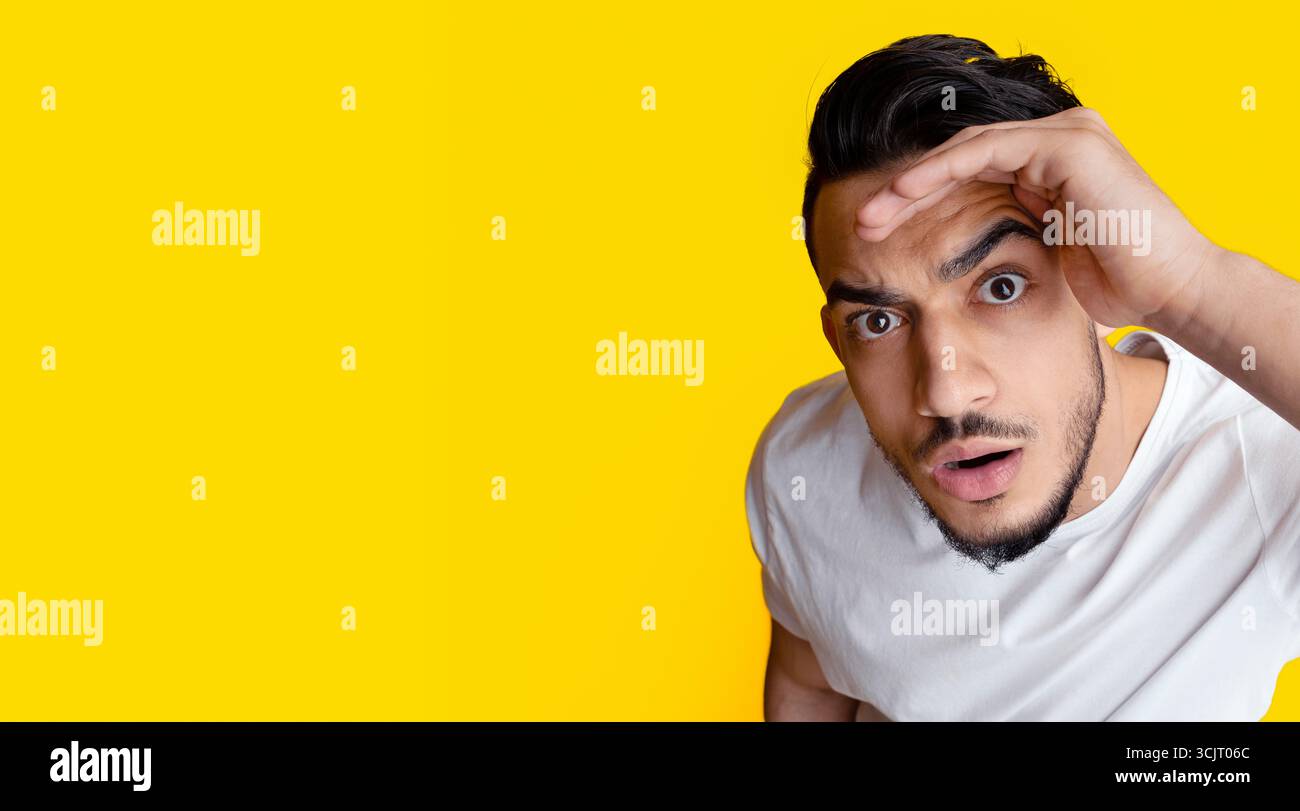 Top view of surprised middle eastern guy looking at camera Stock Photo