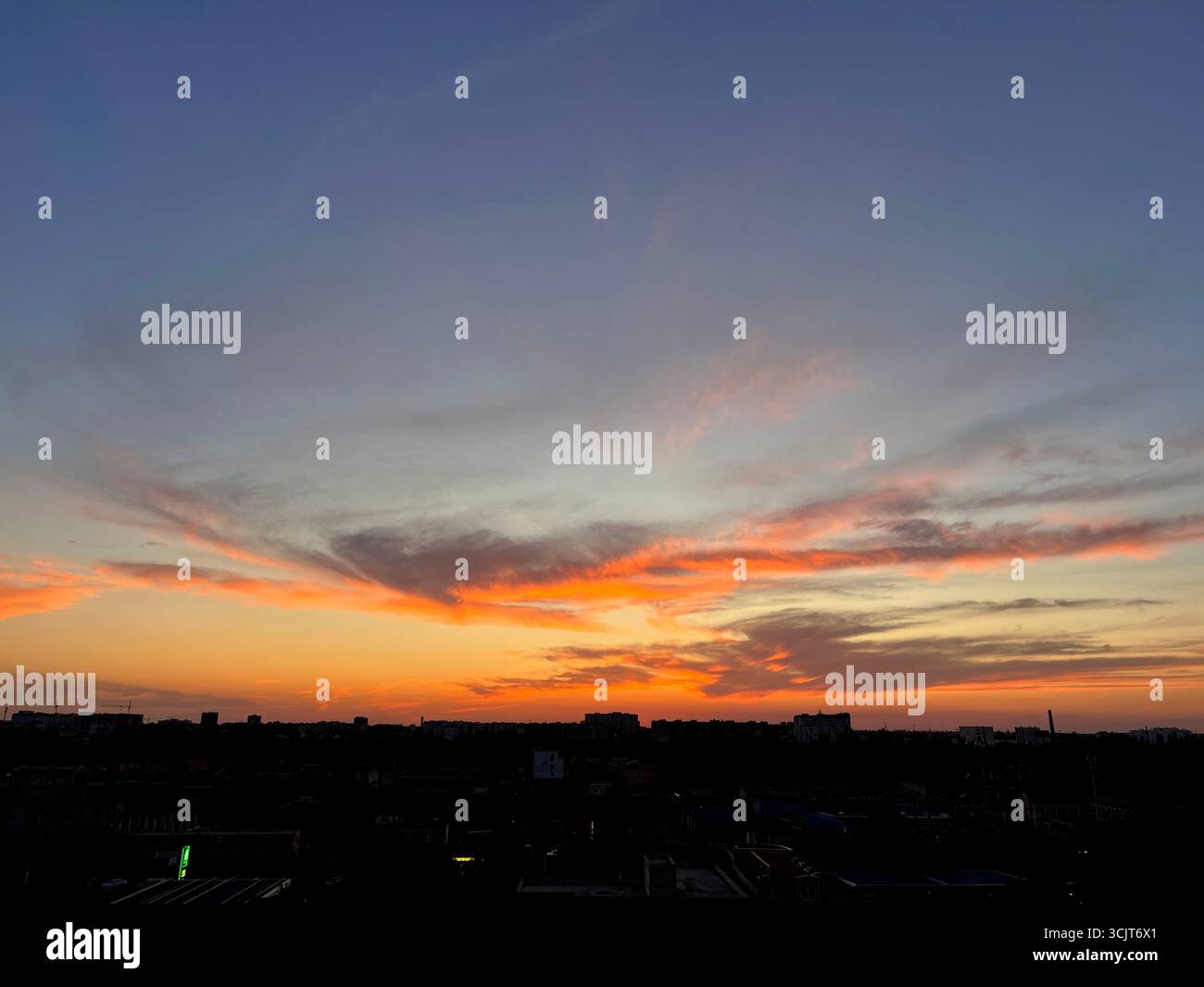 orange sunset with lilac-gray clouds, sunset over the city - Smartphone Captured Stock Image