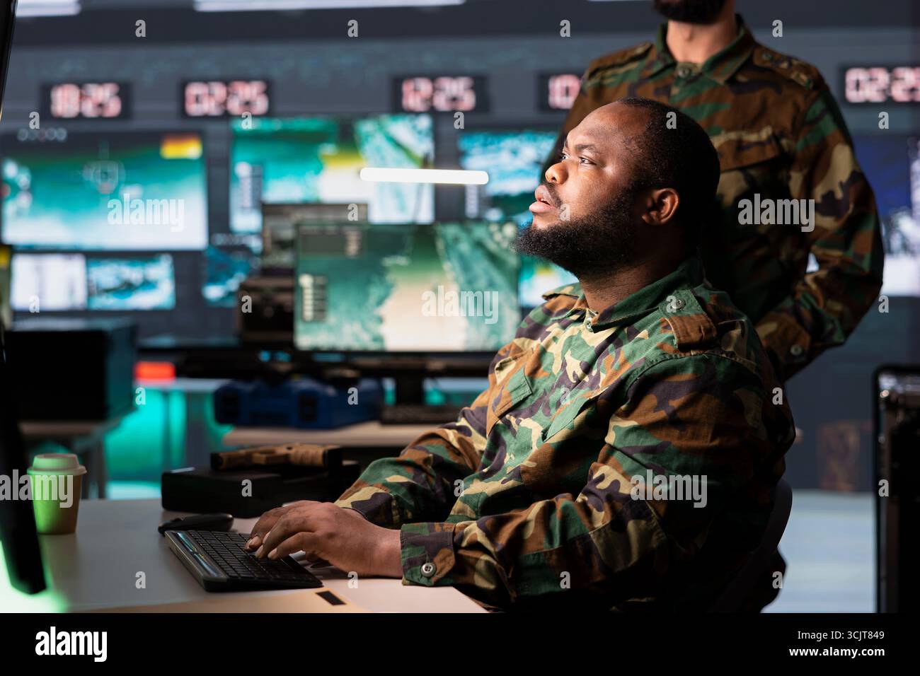 Soldier looking at monitors in control room housing operational missile ...
