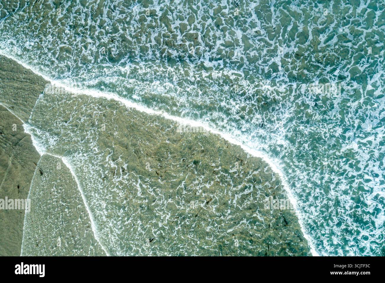 The serene and calming texture of a gentle wave on the beach A Moment of Serenity Stock Photo