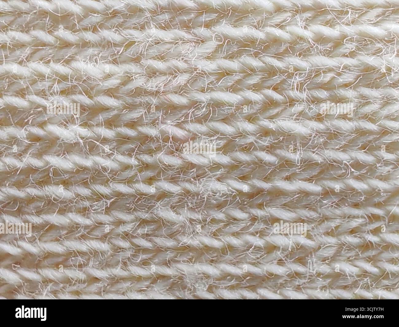 Seamless Macro Texture Of A Light Cream colored Knit Fabric Showcasing seamless-macro-texture-of-a-light-cream-colored-knit-fabric-showcasing
