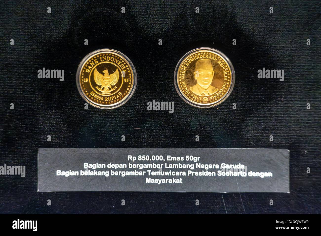 Close-up showcases two commemorative gold coins from Indonesia ...