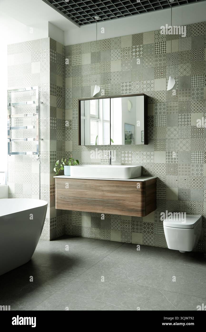 Modern Bathroom Interior Featuring Floating Vanity and Patterned Tile Walls Stock Photo