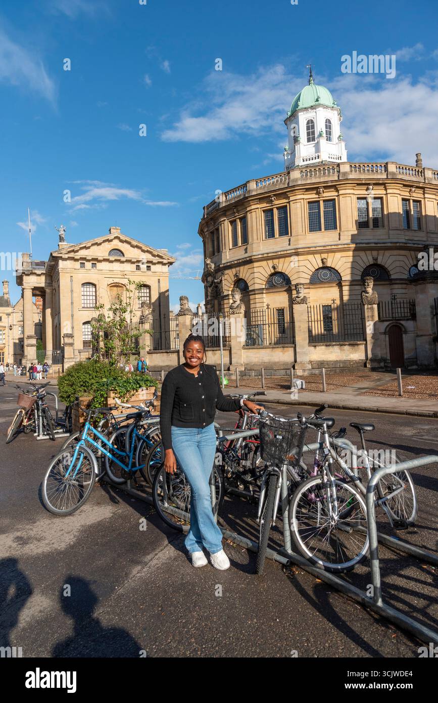 Oxford England UK. 01.09.2025. African woman touring Oxford city centre on a cycling visit to the city. Stock Photo