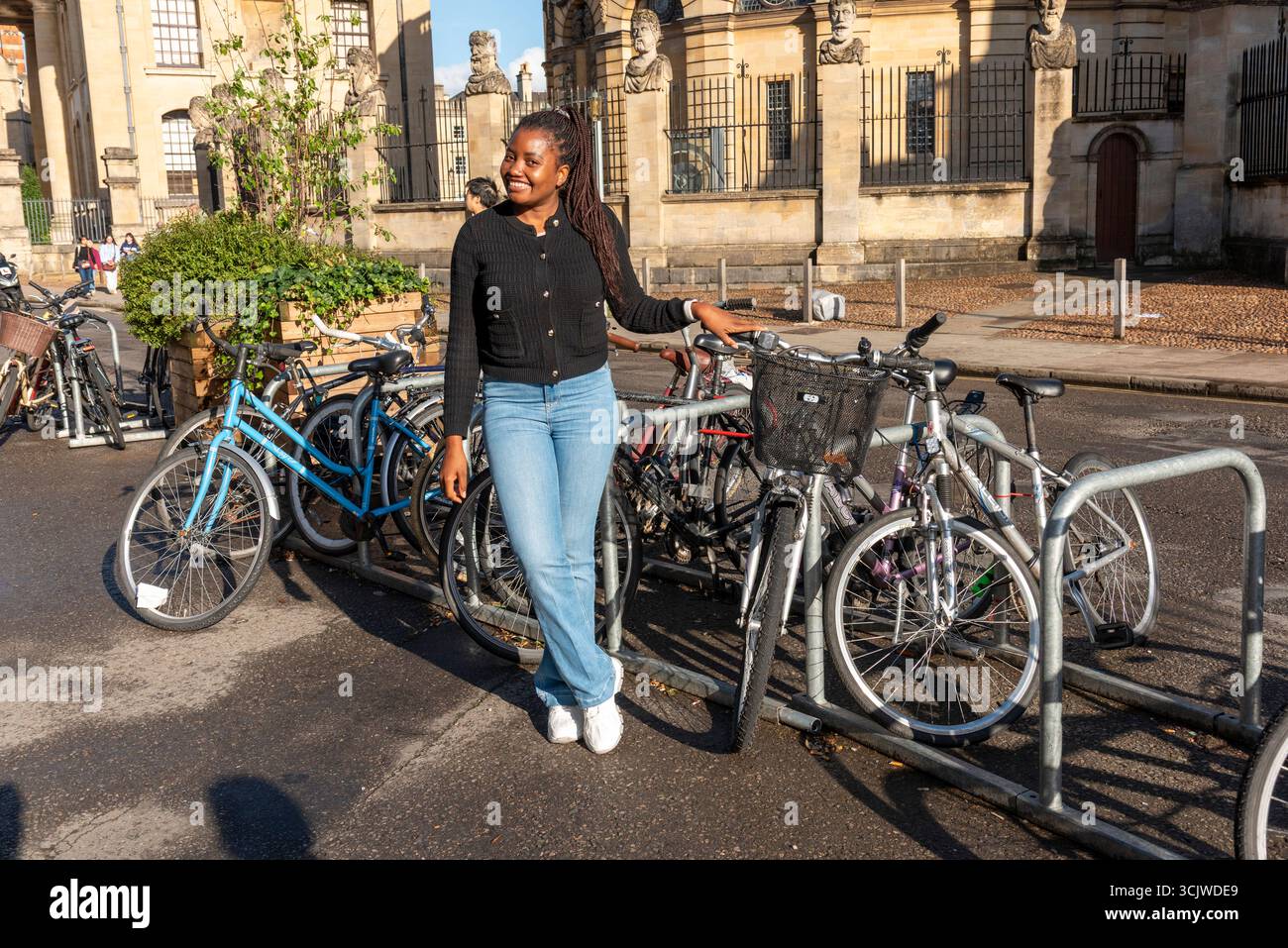 Oxford England UK. 01.09.2025. African woman touring Oxford city centre on a cycling visit to the city. - Stock Image
