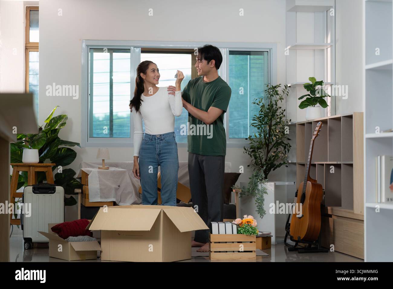 Unpacking Process Couple Celebrating Unpacking Process in Modern Home Stock Photo - Alamy