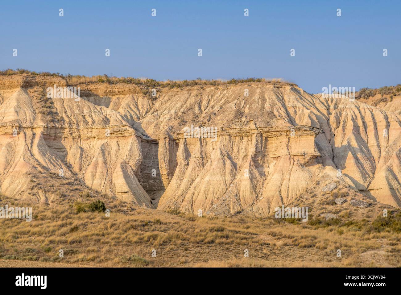 Spectacular Layered Rock Formations in Bardenas Reales Natural Park Navarra Spain. Erosion badlands, golden hour light, semi-desert landscape, cliffs Stock Photo