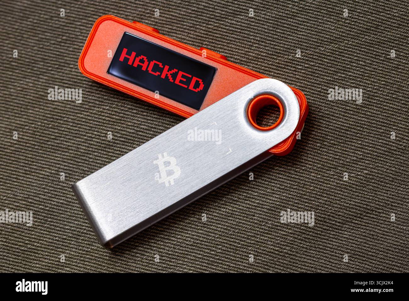 orange hardware Bitcoin cold wallet with stolen message on screen Stock  Photo - Alamy