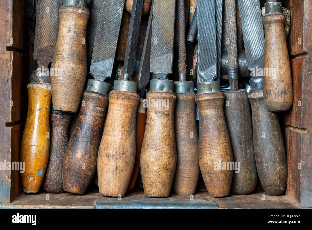 Old vintage rasps with wooden handles in wooden tool box . A set of ...