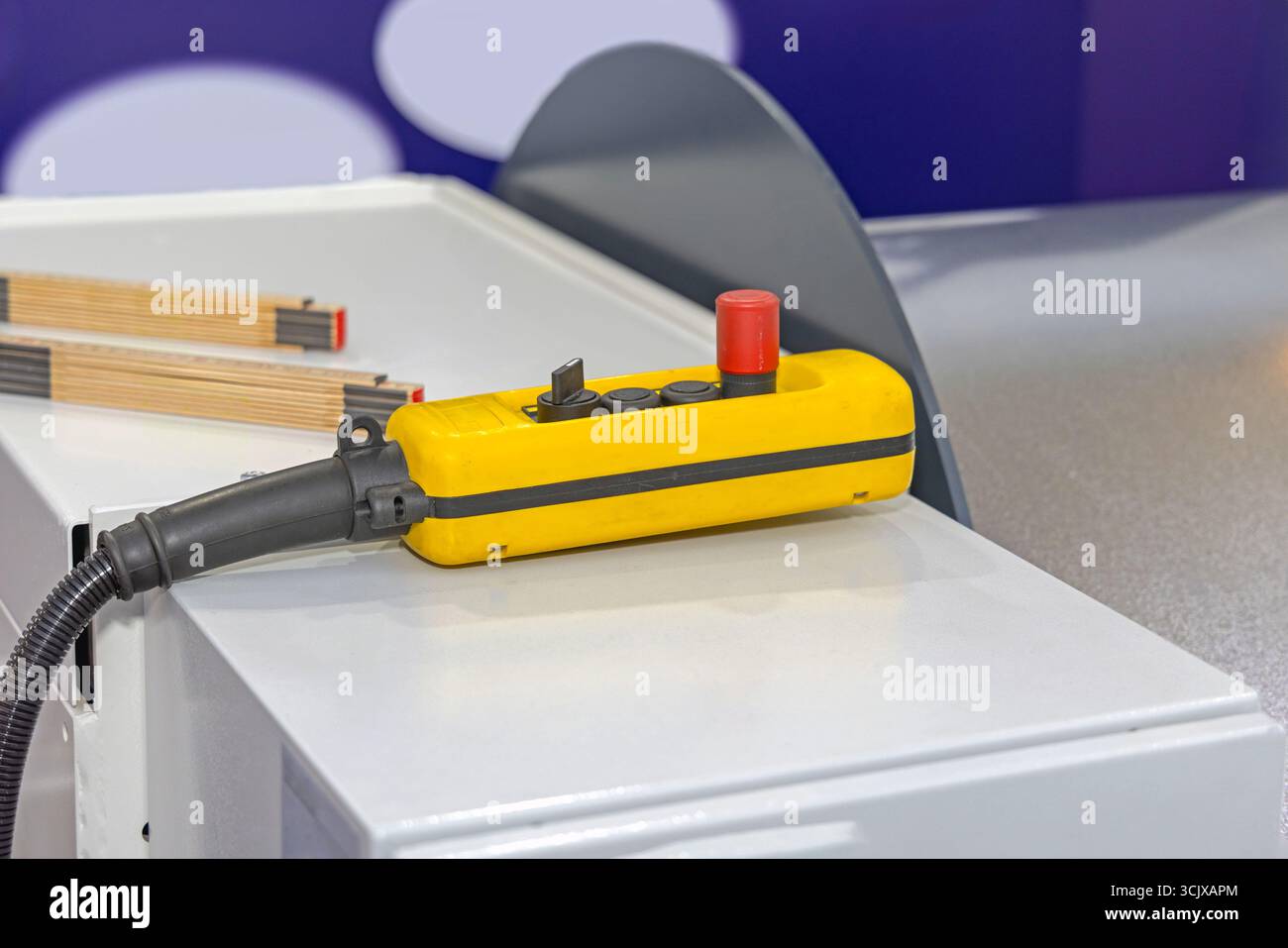 Wired Remote Control Machine With Emergency Stop Button in Factory Stock Photo