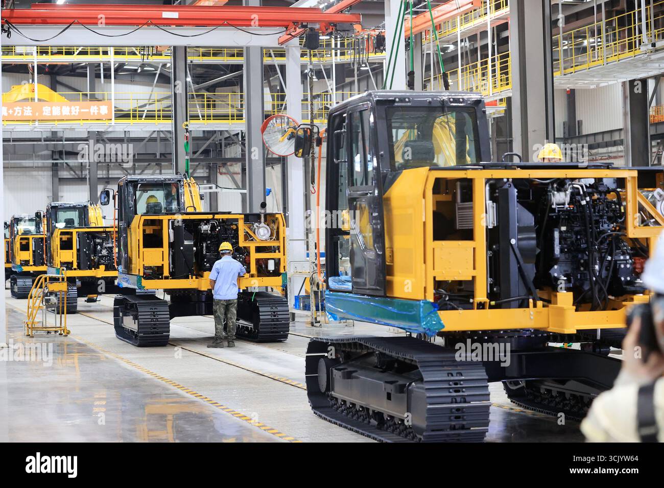 LIUZHOU, CHINA - SEPTEMBER 9, 2025 - Workers assemble excavators in the ...
