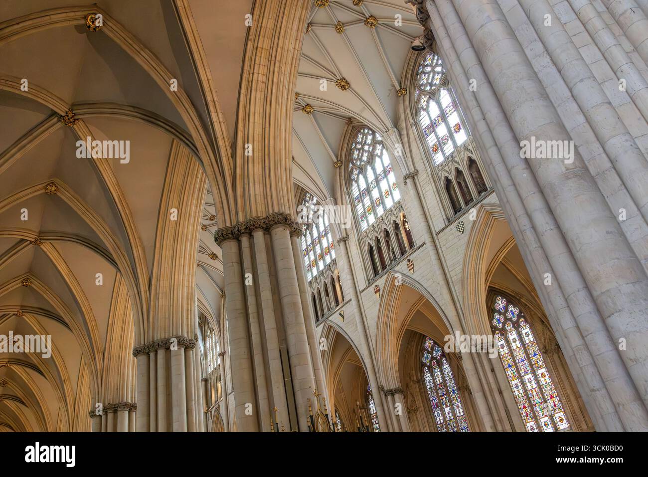 Gothic interior of York Minster with ribbed vaults, pointed arches, and stained glass an awe inspiring symbol of medieval spirituality. Stock Photo