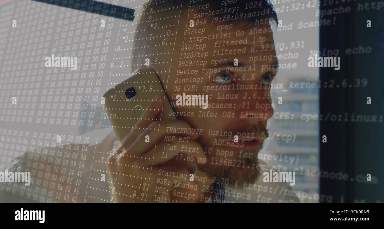 Talking on gold phone, engineer in checkered shirt gazing out office window, with network overlay Stock Photo