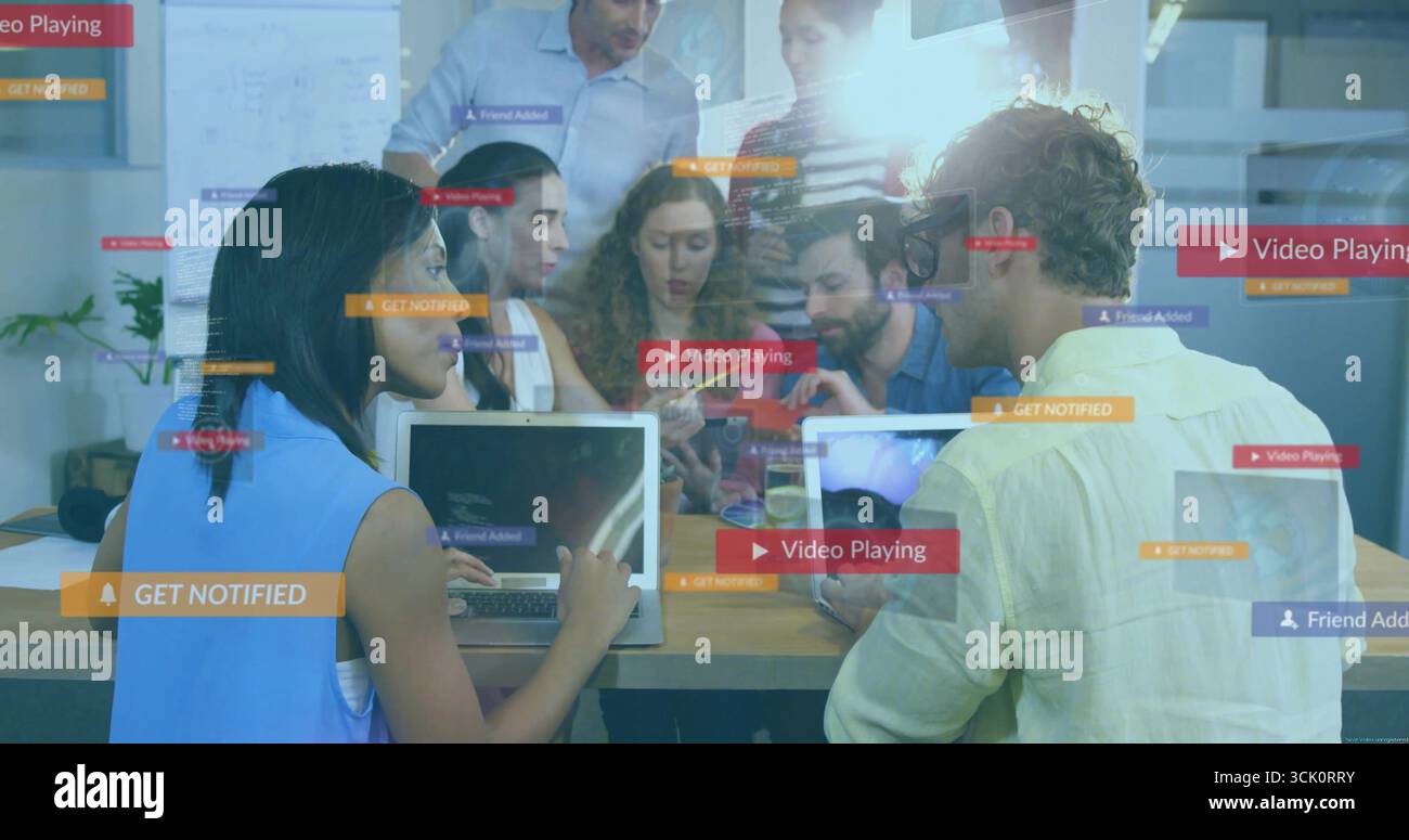 Collaborating office team exploring floating interface graphics in conference room, with laptops Stock Photo
