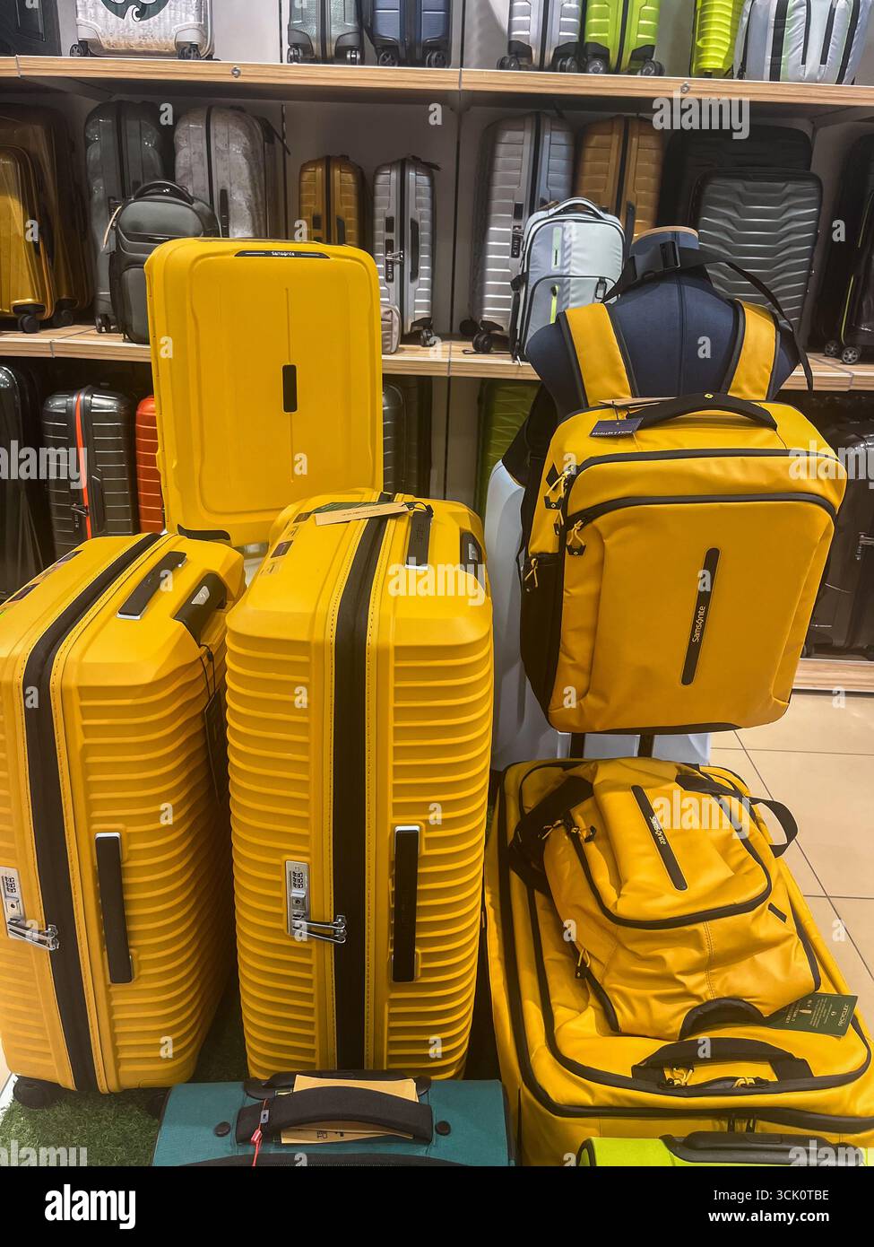 Riga, Latvia - September 04, 2025: Samsonite travel bags in bright yellow are arranged in a store, highlighting their stylish design and practical fea Stock Photo