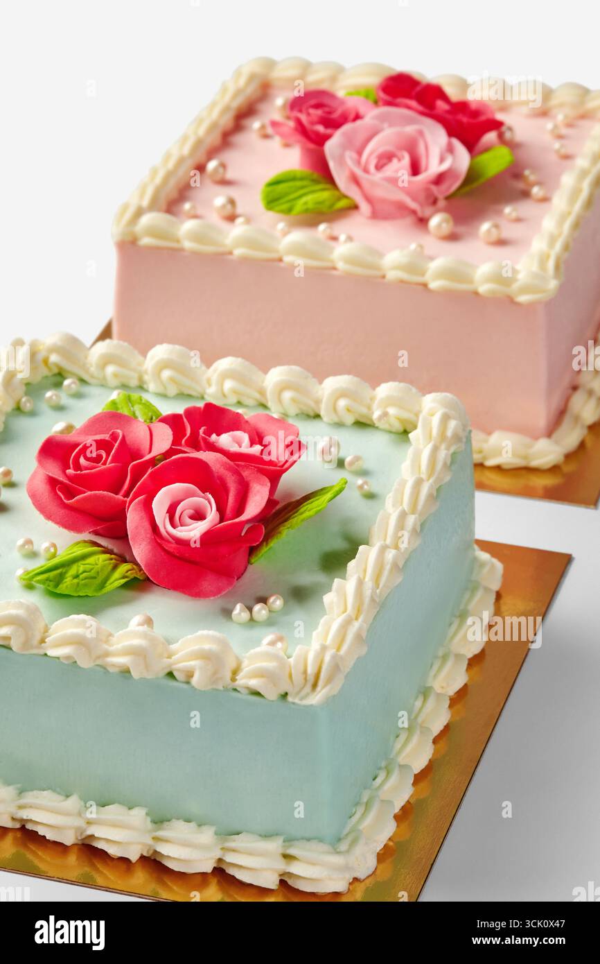 Delicious square cakes decorated with fondant roses and pearls Stock Photo