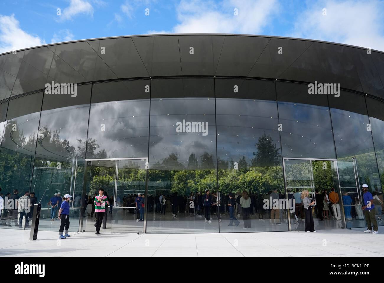Attendees wait inside the Steve Jobs Theater for an announcement of new ...