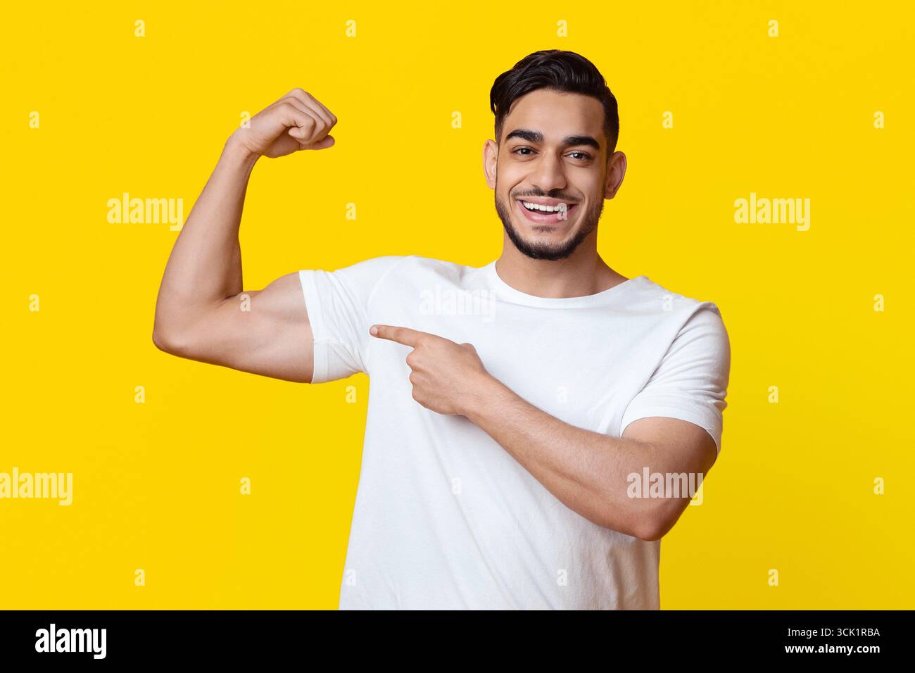 Athletic middle eastern man showing his muscles Stock Photo