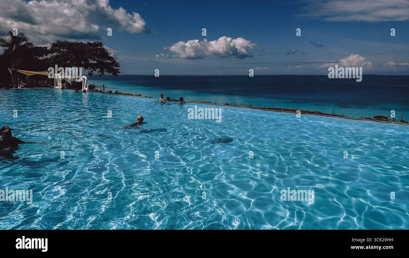 Tropical beach with sand, turquoise ocean and palm on Zanzibar Island, Tanzania, East Africa - Smartphone Captured Stock Image