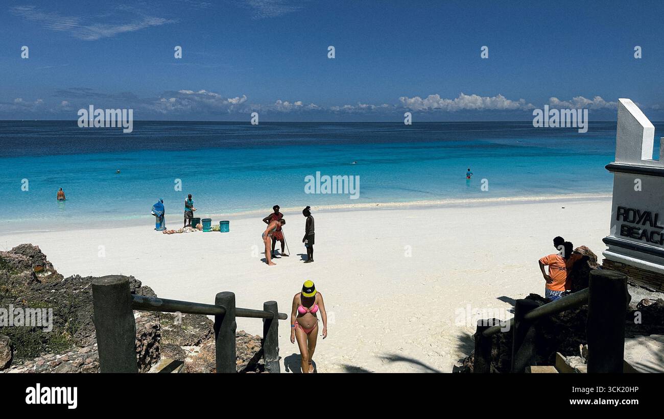 Tropical beach with sand, turquoise ocean and palm on Zanzibar Island, Tanzania, East Africa - Smartphone Captured Stock Image