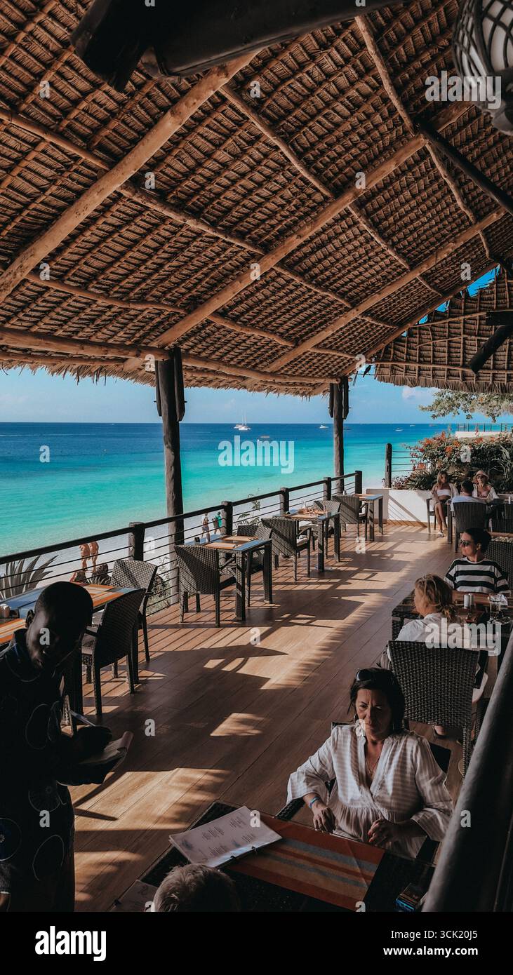 Tropical beach with sand, turquoise ocean and palm on Zanzibar Island, Tanzania, East Africa - Smartphone Captured Stock Image