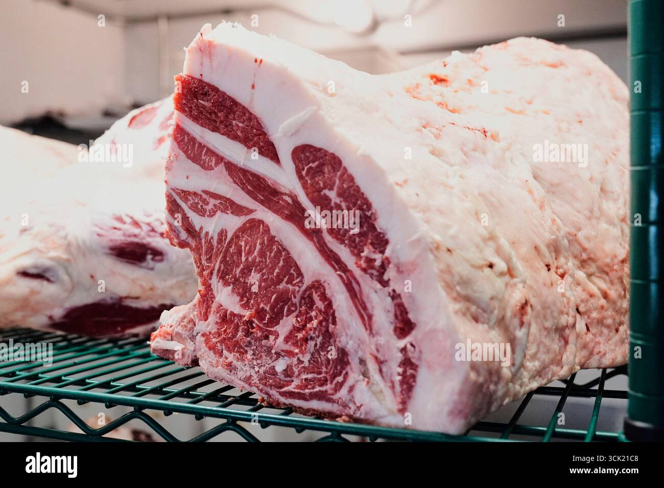 Large primal cuts of beef sit on a rack in a cooler at Deep Cuts ...