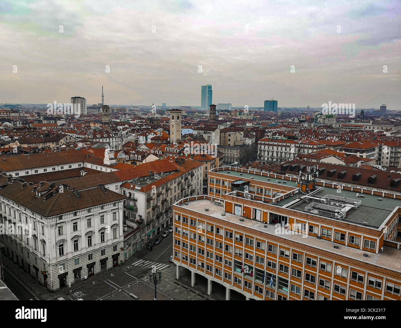 An elevated view of the historic city of Turin. The moody, cloudy sky provides a dramatic backdrop for the Renaissance architecture, highlighting the - Smartphone Captured Stock Image