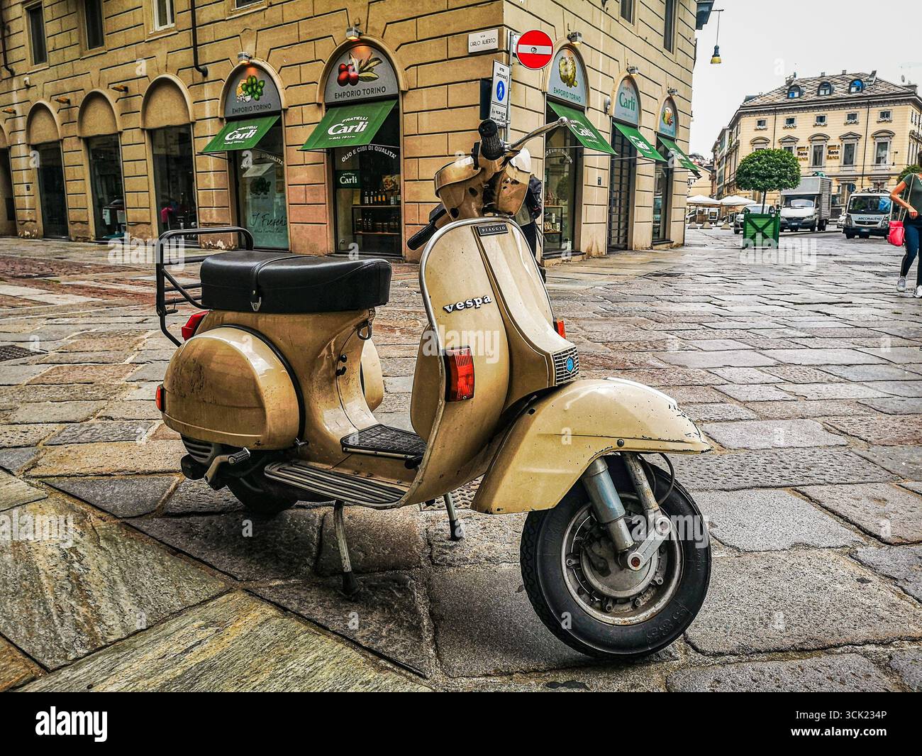 A low-angle shot of a classic Vespa scooter on the historic Via ...