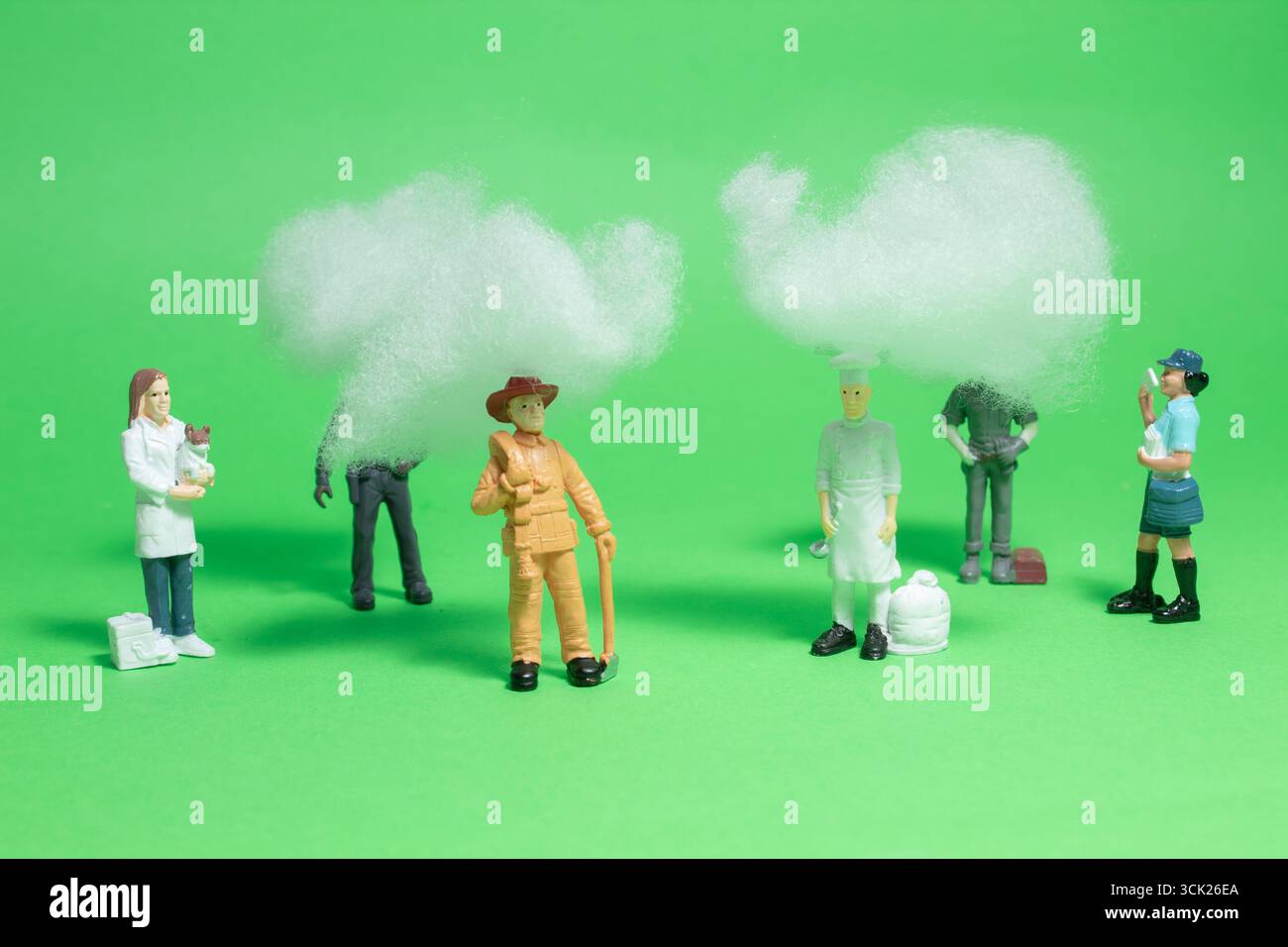 Miniature people have headaches and mental health pains, struggle with stress, fatigue, brain fog, or migraines. Stock Photo