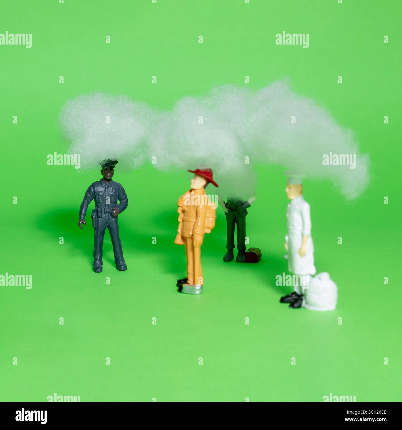Miniature people have headaches and mental health pains, struggle with stress, fatigue, brain fog, or migraines. Stock Photo